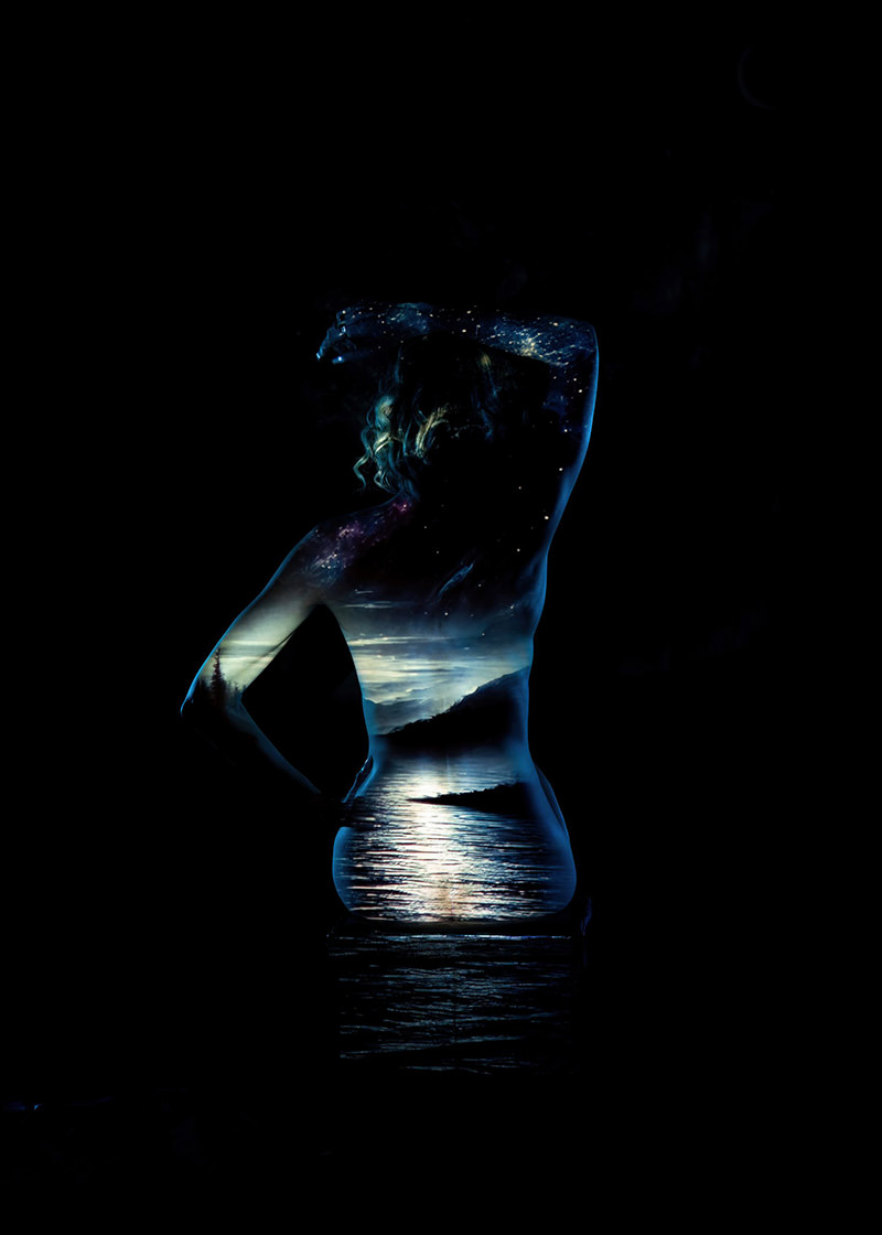 Back view of a person with an artistic overlay of a night sky filled with stars and a tranquil lake reflecting light, creating a cosmic landscape on their silhouette against a black background