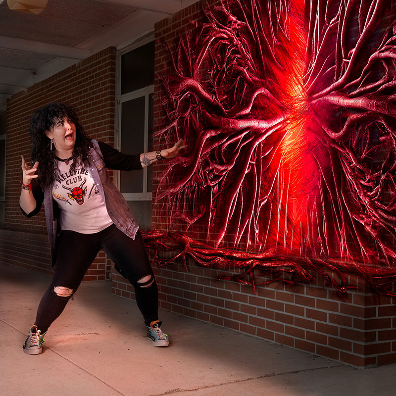 Cosplay confronting glowing red portal